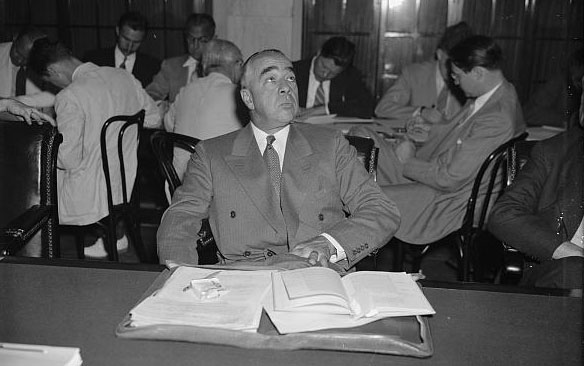 Joseph N. Pew, Jr. sits at a table with papers