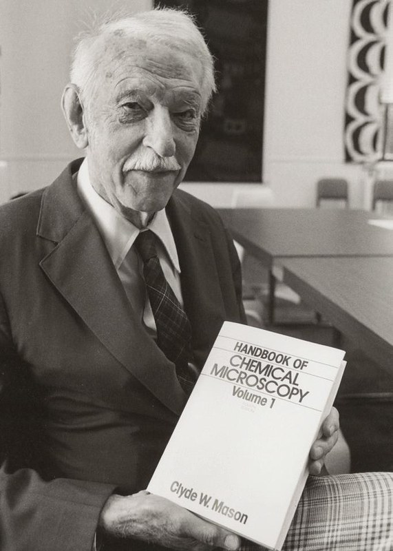 Clyde Mason holds his book Handbook of Chemical Microscopy
