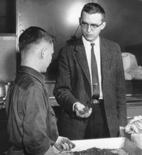 James W. Spencer and Chuck Ditmars perform hand soil tests in 1956