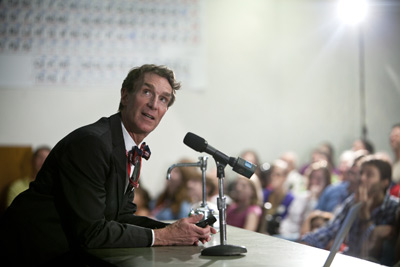 Bill Nye on stage with an enthusaistic audience