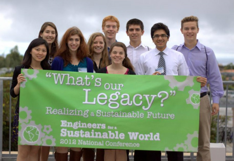 Group holds up banner with "What's Our Legacy" Realizing a Sustainable Future