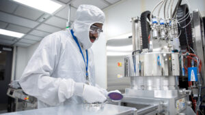 student in protective clothing working in a laboratory